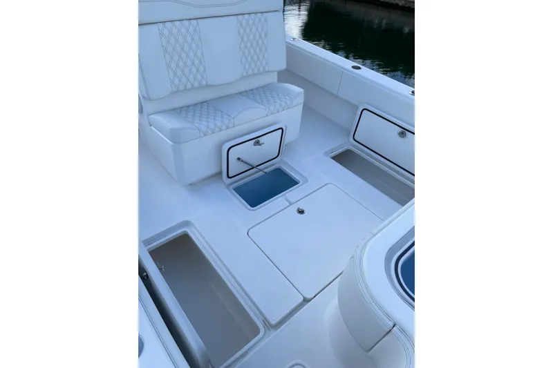 Slide: The Image of 2024 Invincible 36 Open Fisherman boat interior with storage compartments and seating. - 11