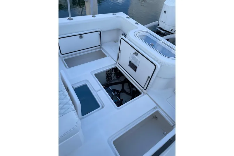 Slide: The Image of 2024 Invincible 36 Open Fisherman boat deck with storage compartments open. - 12