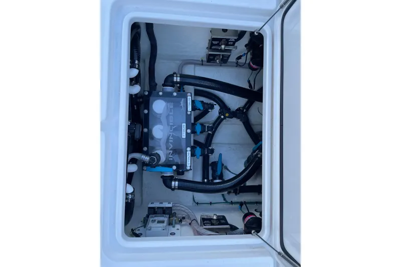 Slide: The Image of 2024 Invincible 36 Open Fisherman boat plumbing system with hoses and valves. - 13