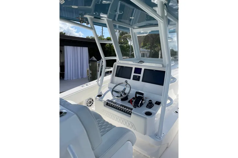 Slide: The Image of 2024 Invincible 36 Open Fisherman boat cockpit with modern controls and dual screens. - 17