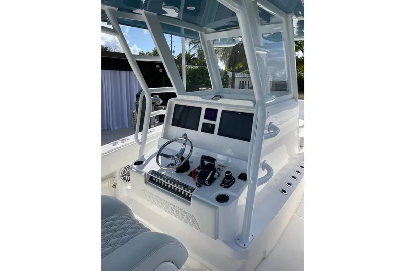 Slide: The Image of 2024 Invincible 36 Open Fisherman boat cockpit with modern controls and steering wheel. - 18