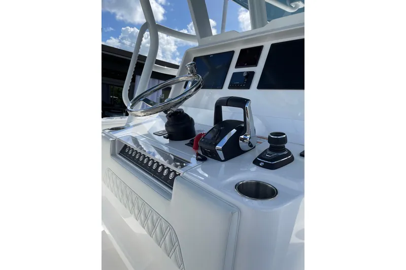 Slide: The Image of 2024 Invincible 36 Open Fisherman helm with modern controls and steering wheel. - 19