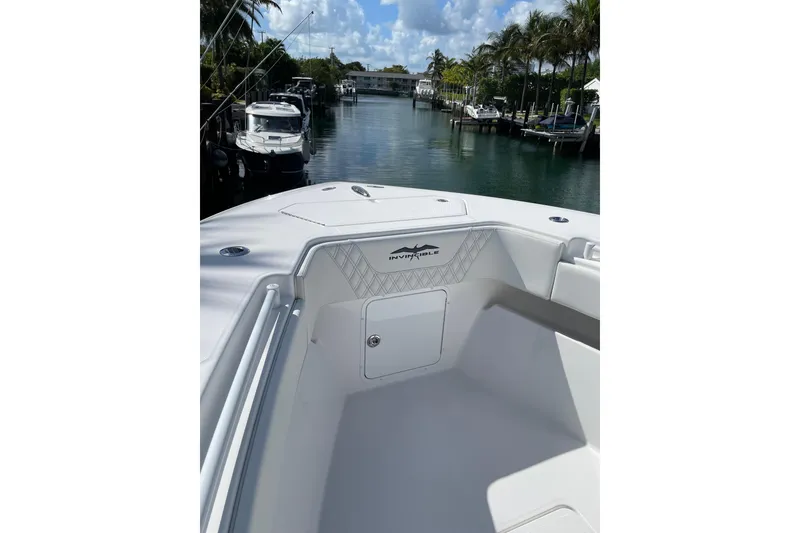 Slide: The Image of 2024 Invincible 36 Open Fisherman boat docked in a scenic marina. - 21