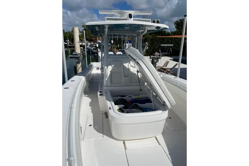 Slide: The Image of 2024 Invincible 36 Open Fisherman boat with open storage compartment, docked at marina. - 27