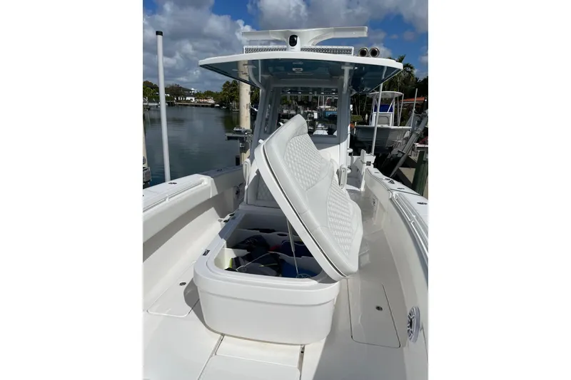 Slide: The Image of 2024 Invincible 36 Open Fisherman boat with open storage compartment, docked by the water. - 28