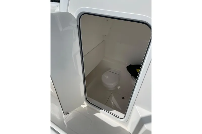 Slide: The Image of 2024 Invincible 36 Open Fisherman boat interior with compact marine toilet. - 31