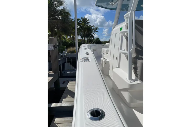 Slide: The Image of 2024 Invincible 36 Open Fisherman boat docked, showcasing sleek design and spacious deck. - 7