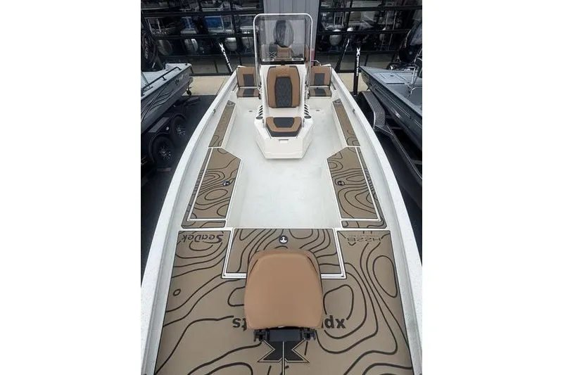 Slide: The Image of 2026 Xpress H22 boat interior with brown and black seating, featuring a sleek design. - 15