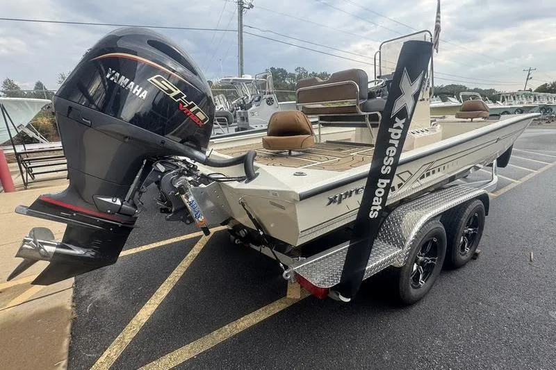 Slide: The Image of 2026 Xpress H22 boat with Yamaha engine on a trailer in a parking lot. - 6
