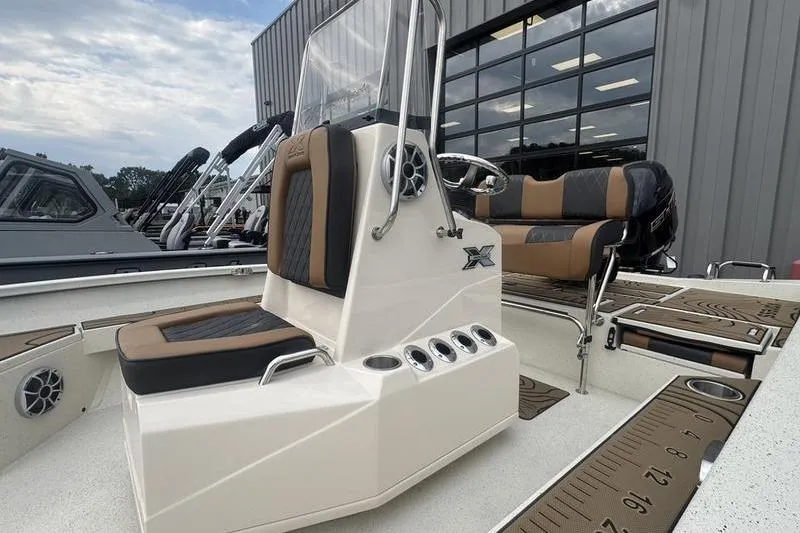Slide: The Image of 2026 Xpress H22 boat with sleek seating and modern design in a showroom. - 8