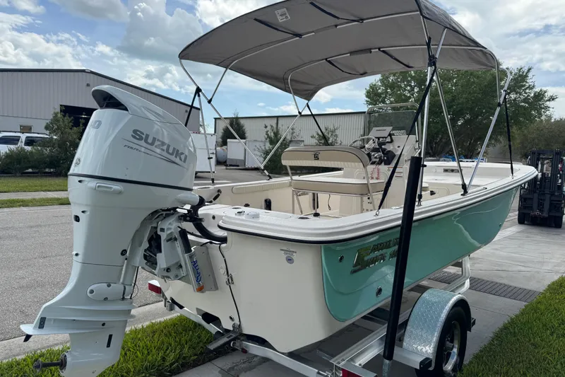 Slide: The Image of 2022 Carolina Skiff 19 LS boat with Suzuki outboard motor on trailer. - 14