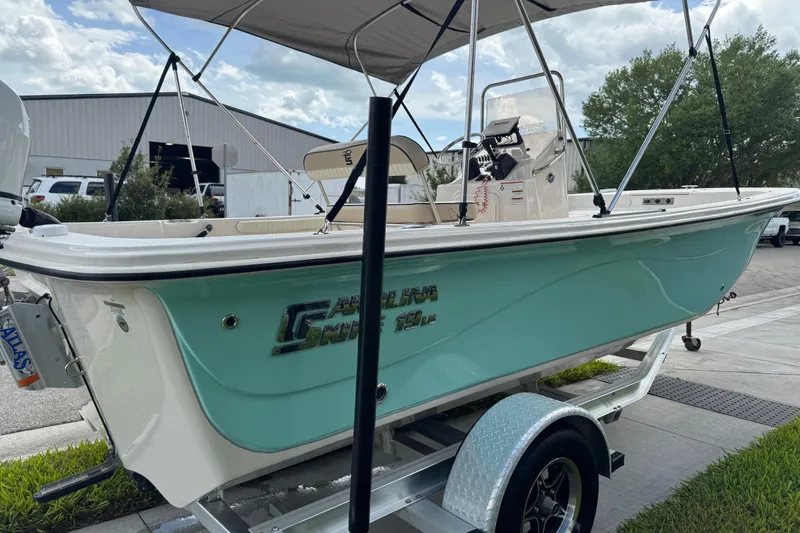 Slide: The Image of 2022 Carolina Skiff 19 LS boat on trailer, light blue hull, outdoor setting. - 15