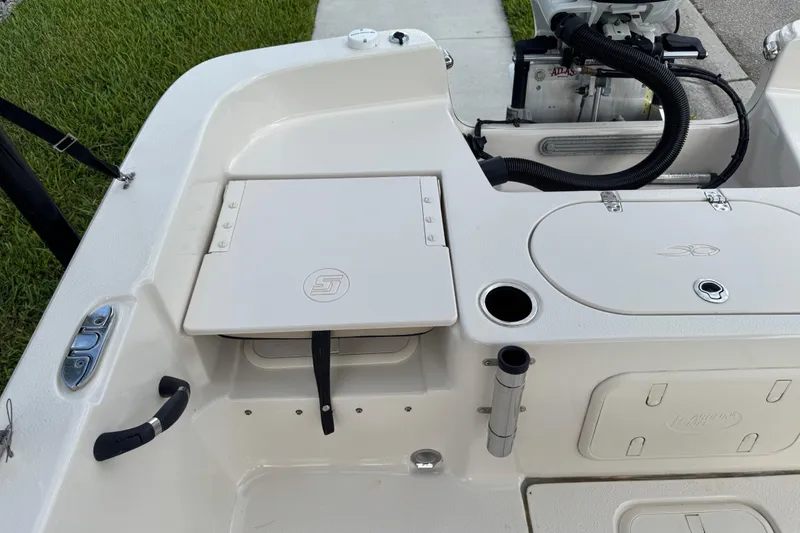 Slide: The Image of 2022 Carolina Skiff 19 LS boat interior with storage compartments and motor details. - 24
