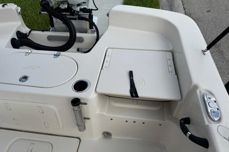 Slide: The Image of 2022 Carolina Skiff 19 LS boat interior with storage compartments and motor controls. - 26