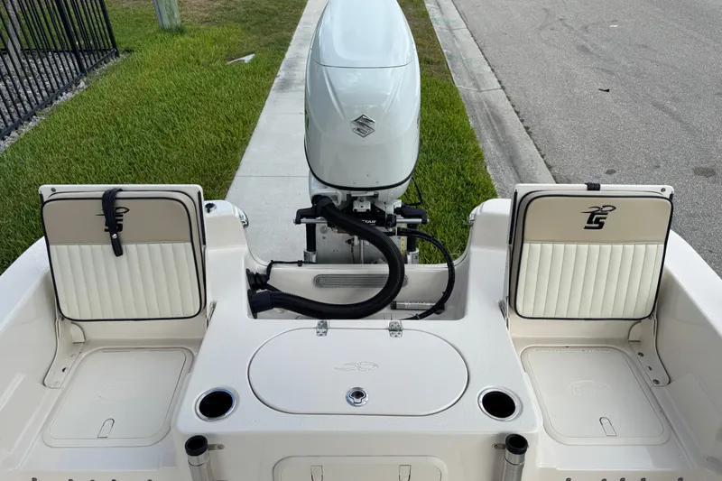 Slide: The Image of 2022 Carolina Skiff 19 LS boat with outboard motor and seating, parked on roadside. - 28