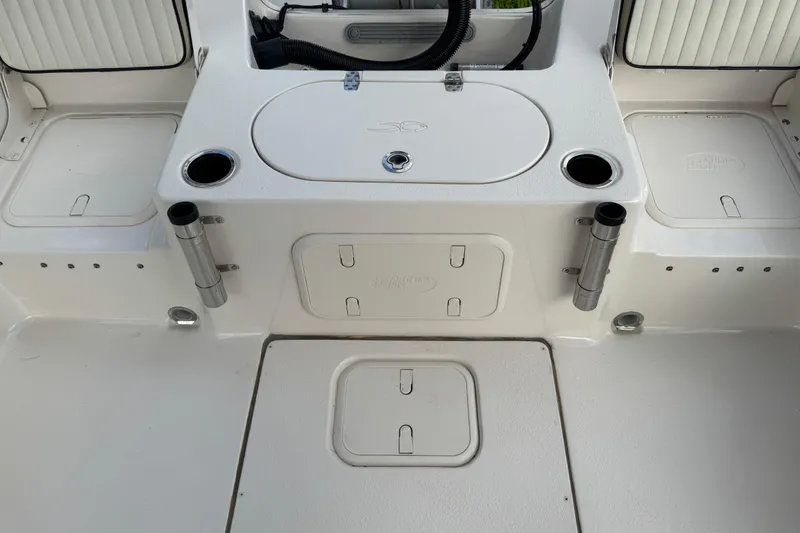 Slide: The Image of 2022 Carolina Skiff 19 LS boat interior with storage compartments and rod holders. - 29