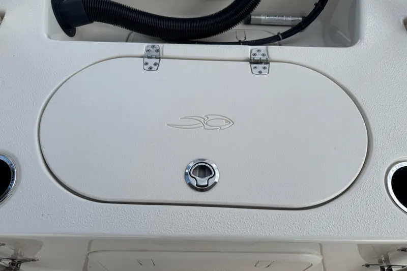 Slide: The Image of 2022 Carolina Skiff 19 LS boat hatch with fish emblem and cup holders. - 30