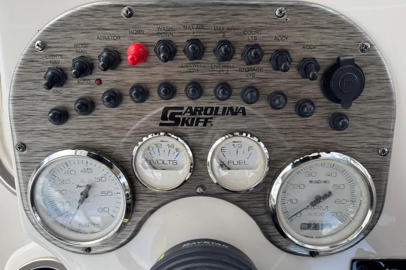 Slide: The Image of Dashboard of a 2022 Carolina Skiff 19 LS boat with gauges and switches. - 37