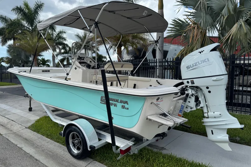 Slide: The Image of 2022 Carolina Skiff 19 LS boat with Suzuki outboard motor on trailer. - 4