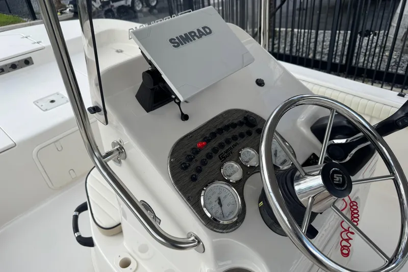 Slide: The Image of 2022 Carolina Skiff 19 LS boat dashboard with steering wheel and Simrad display. - 40