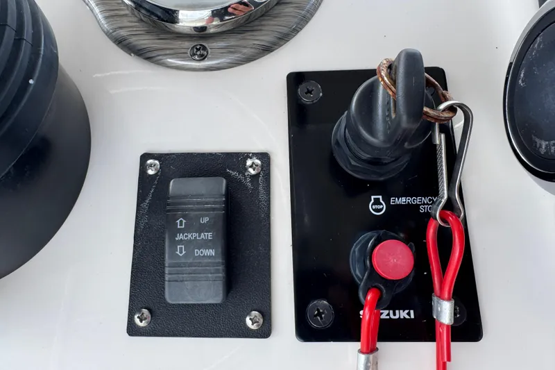 Slide: The Image of Control panel of a 2022 Carolina Skiff 19 LS with jackplate switch and emergency stop. - 42