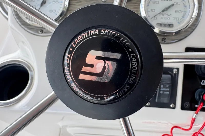 Slide: The Image of Steering wheel of 2022 Carolina Skiff 19 LS boat with gauges and controls. - 46