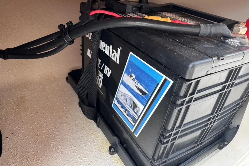 Slide: The Image of Battery compartment of a 2022 Carolina Skiff 19 LS boat with marine battery. - 59