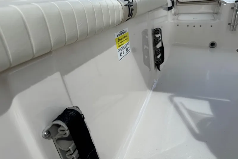 Slide: The Image of Interior view of a 2022 Carolina Skiff 19 LS boat, featuring seating and safety labels. - 70