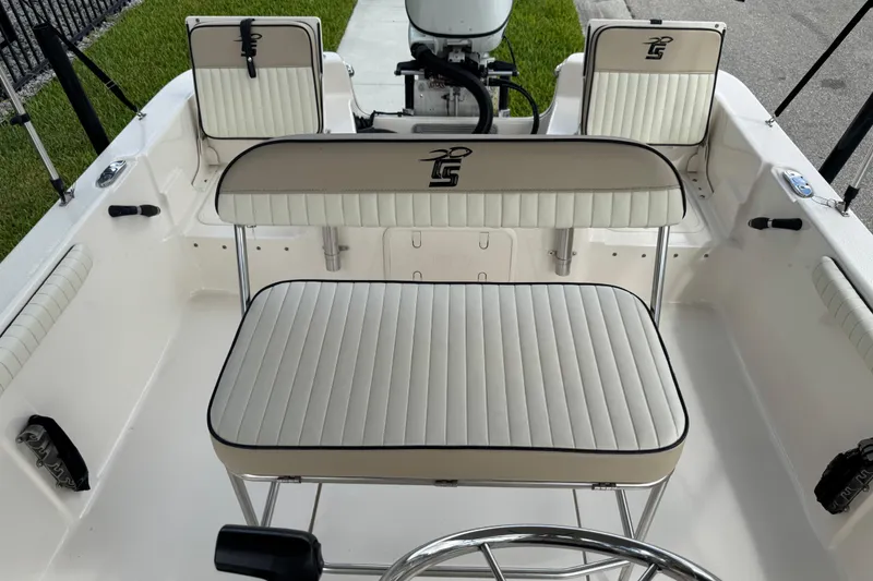 Slide: The Image of 2022 Carolina Skiff 19 LS boat interior with cushioned seating and steering wheel. - 77