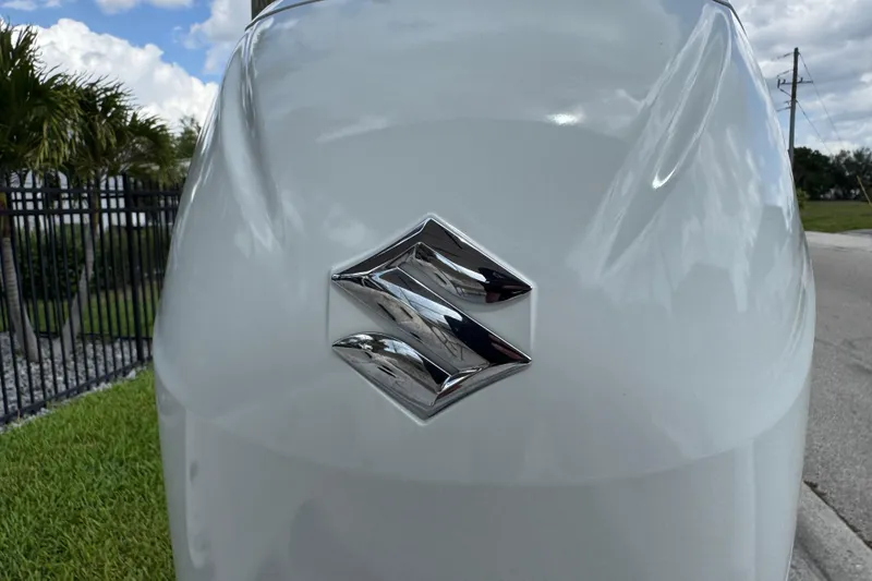Slide: The Image of Close-up of Suzuki logo on a 2022 Carolina Skiff 19 LS boat. - 79