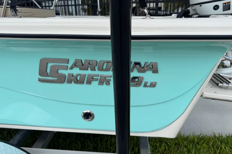 Slide: The Image of 2022 Carolina Skiff 19 LS boat with turquoise hull and logo detail. - 82