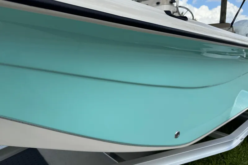 Slide: The Image of 2022 Carolina Skiff 19 LS boat with sleek turquoise hull design. - 83