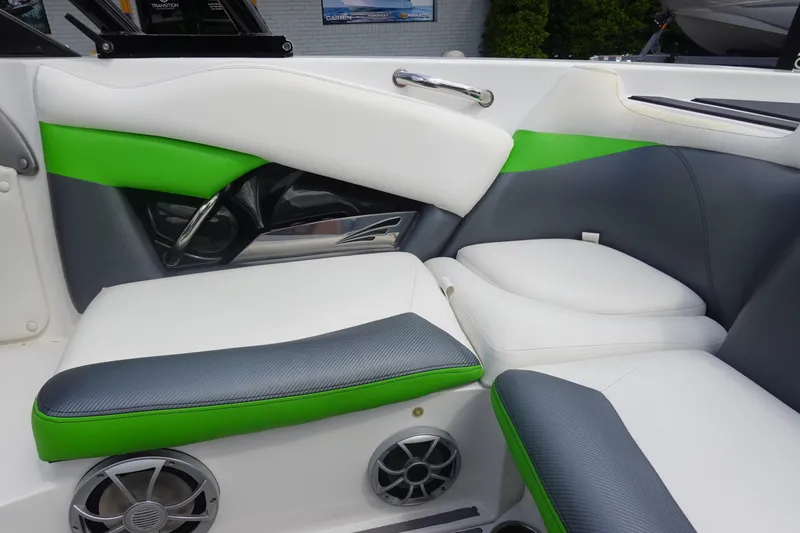 Slide: The Image of 2015 Tigé R20 boat interior with green, white, and gray seating and speakers. - 11