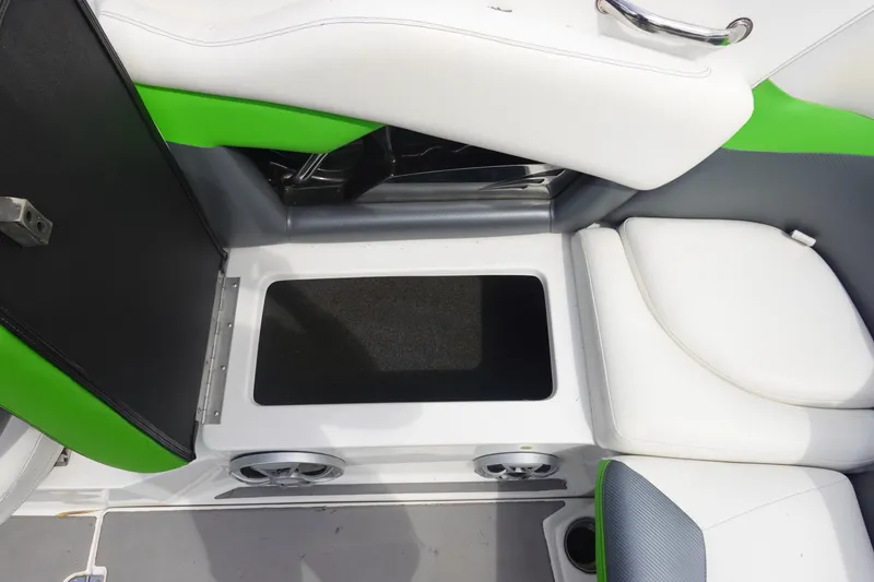 Slide: The Image of Interior seating and storage of a 2015 Tigé R20 boat, featuring white and green upholstery. - 12