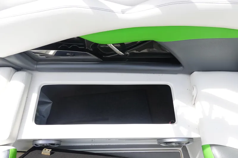Slide: The Image of 2015 Tigé R20 boat interior storage compartment with green and white upholstery. - 14