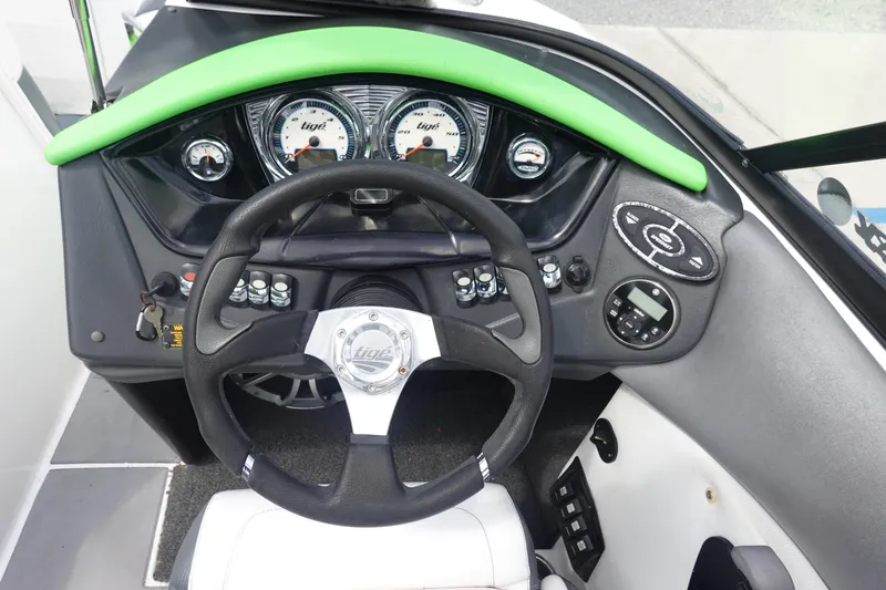 Slide: The Image of 2015 Tigé R20 boat dashboard with steering wheel and control panel. - 17
