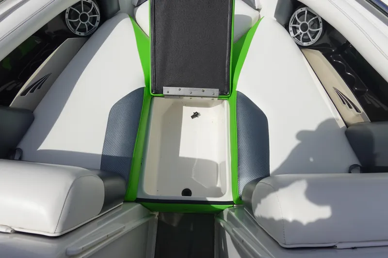 Slide: The Image of 2015 Tigé R20 boat interior with white and green seating, featuring speaker system. - 19