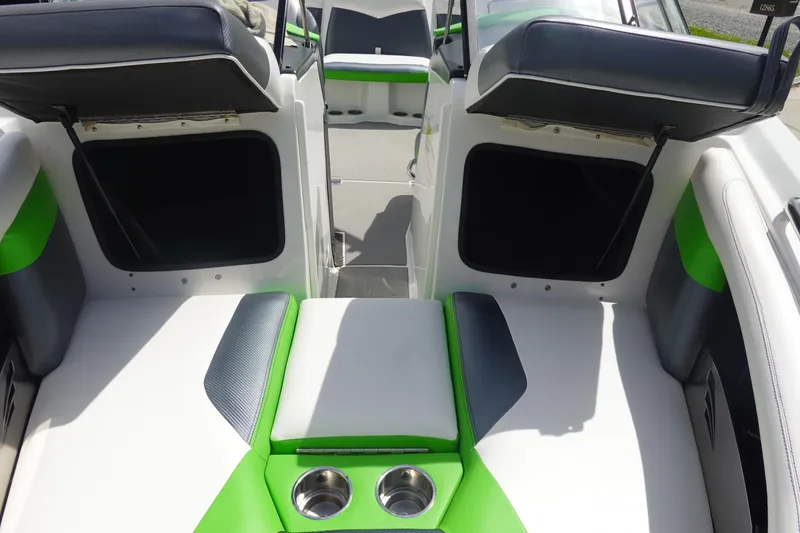 Slide: The Image of Interior of 2015 Tigé R20 boat with green and white seating, featuring cup holders. - 20