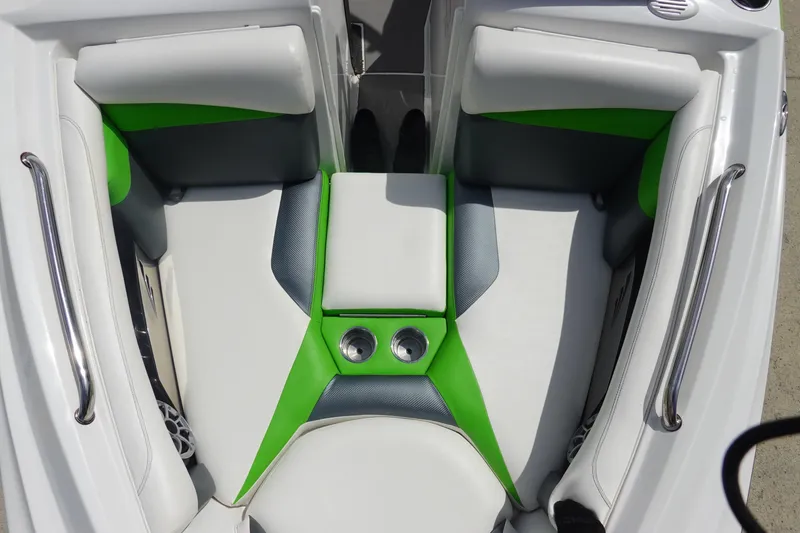 Slide: The Image of 2015 Tigé R20 boat interior with green and white seating, featuring cup holders. - 22