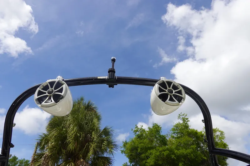 Slide: The Image of Speakers on a 2015 Tigé R20 boat tower against a blue sky backdrop. - 23