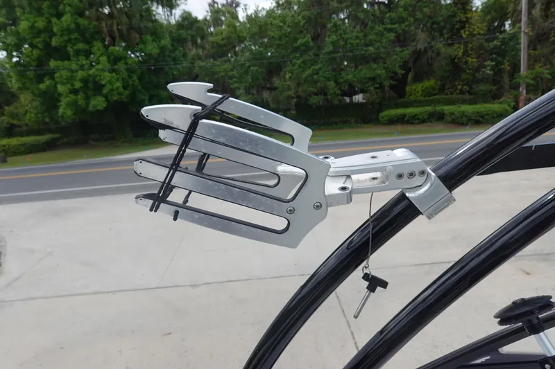 Slide: The Image of 2015 Tigé R20 boat wakeboard rack with key lock, mounted on a black frame. - 24