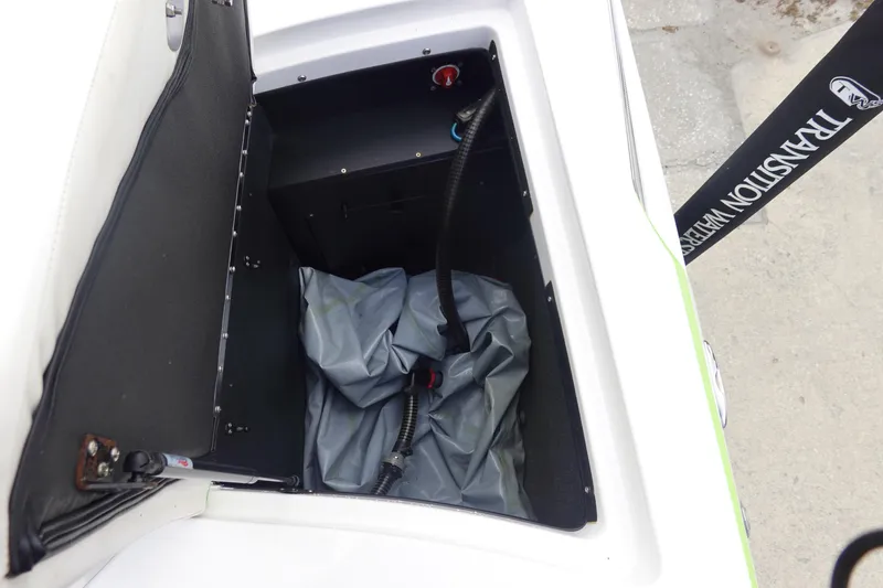 Slide: The Image of Open storage compartment in a 2015 Tigé R20 boat, showing interior details. - 27
