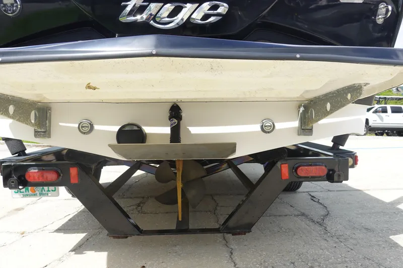 Slide: The Image of Rear view of a 2015 Tigé R20 boat on a trailer, showing propeller and hull details. - 6