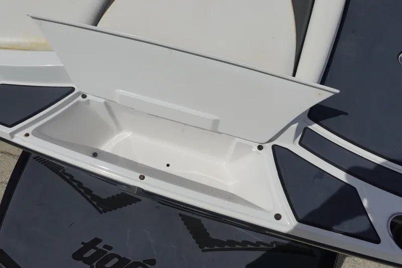Slide: The Image of 2015 Tigé R20 boat storage compartment with open lid, showcasing interior space. - 7