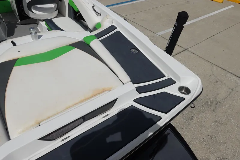 Slide: The Image of 2015 Tigé R20 boat interior with green accents and seating area. - 8