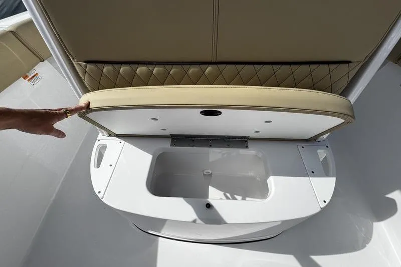 Slide: The Image of 2026 Sportsman Heritage 231 Center Console seat storage compartment open. - 11