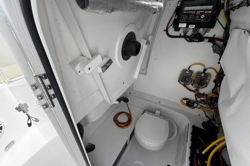 Slide: The Image of Interior view of 2026 Sportsman Heritage 231 Center Console boat, featuring wiring and equipment. - 13