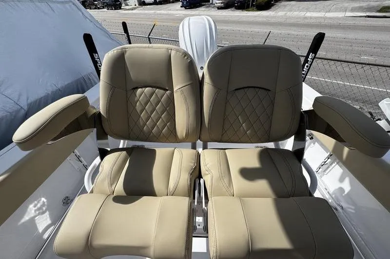 Slide: The Image of 2026 Sportsman Heritage 231 Center Console boat seats, featuring tan upholstery and diamond stitching. - 18