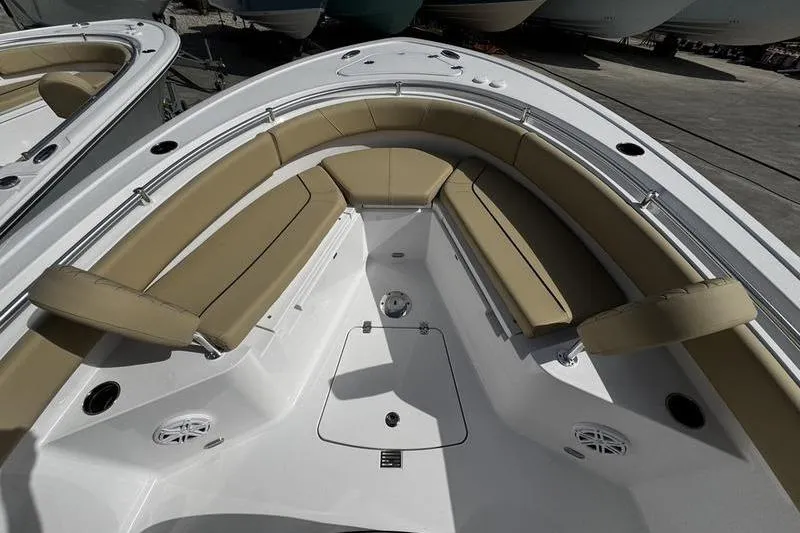 Slide: The Image of 2026 Sportsman Heritage 231 Center Console boat with tan seating and spacious deck. - 2