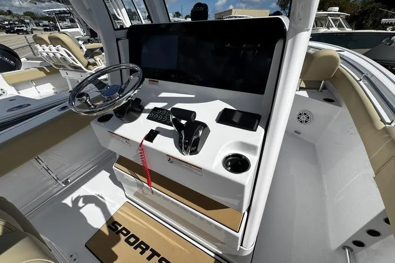 Slide: The Image of 2026 Sportsman Heritage 231 Center Console boat interior with steering wheel and control panel. - 20